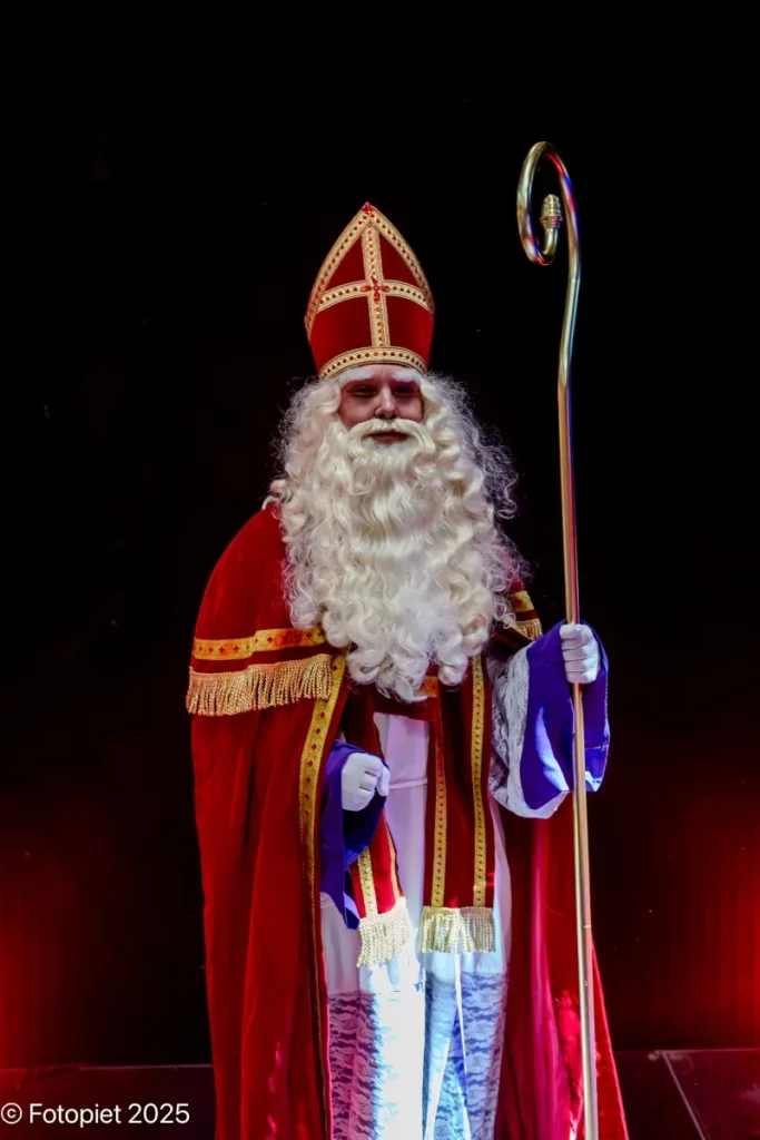 Sinterklaas staat op het podium met zijn staf in 2025.