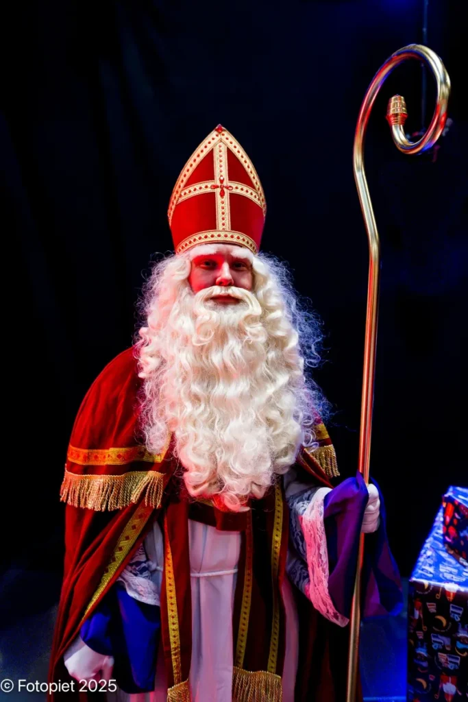 Sinterklaas kijkt de zaal in vanaf het podium in 2025.